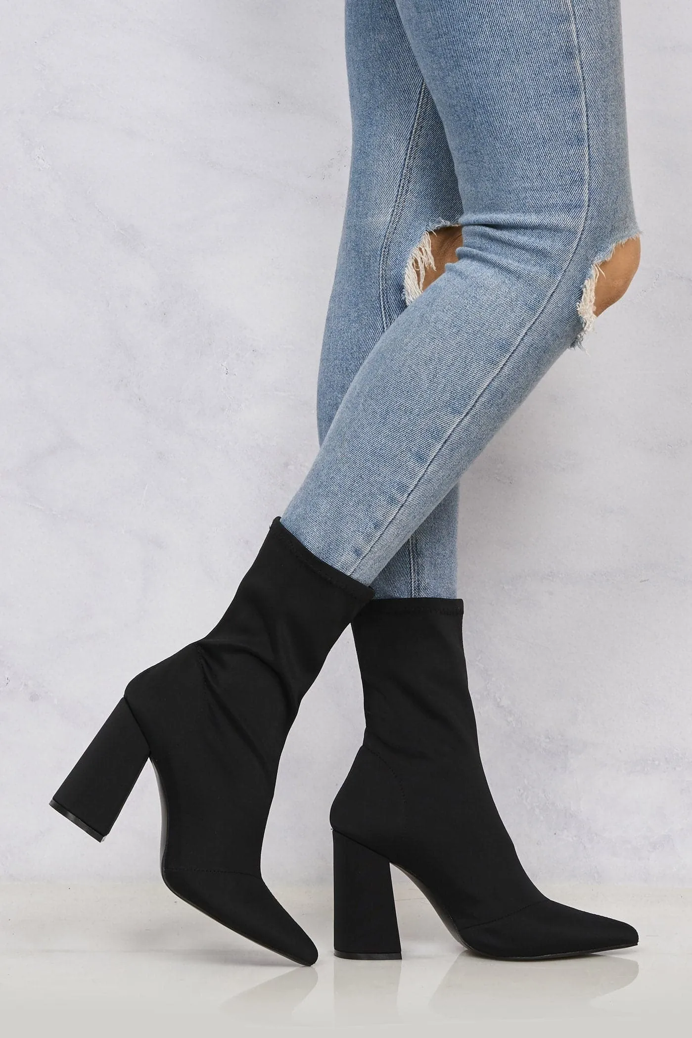 Everly Pointed Toe Flare Heel Calf Boot in Black Lycra