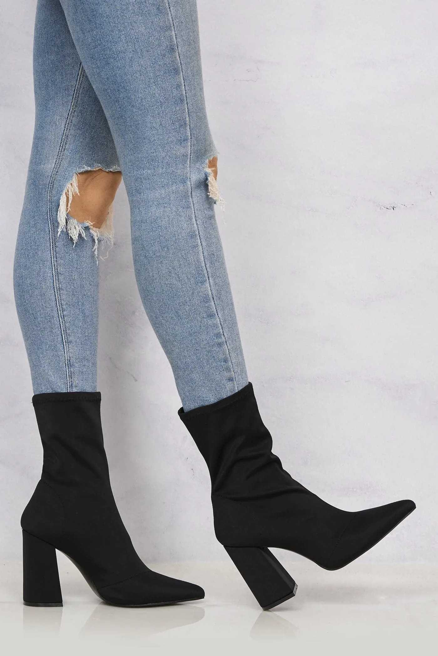 Everly Pointed Toe Flare Heel Calf Boot in Black Lycra